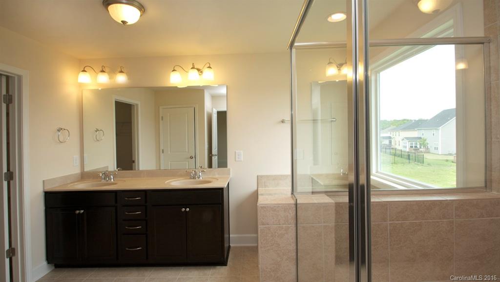 5706 Joshua Cain Road, Unit L0041 Charlotte, NC 28213 - Photo 21 of 23 a bathroom with a double vanity sink and a mirror