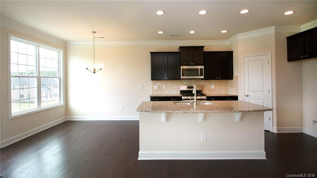 5706 Joshua Cain Road, Unit L0041 Charlotte, NC 28213 - Photo 4 of 23 a view of kitchen with stainless steel appliances wooden floor and window