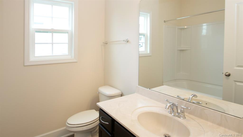 5706 Joshua Cain Road, Unit L0041 Charlotte, NC 28213 - Photo 6 of 23 a bathroom with a sink a toilet and shower