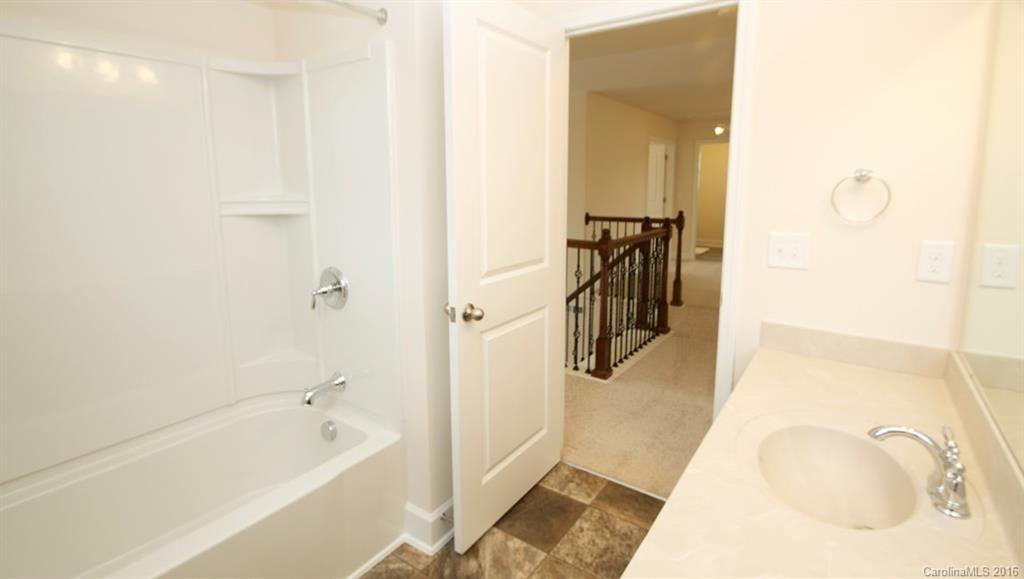 5706 Joshua Cain Road, Unit L0041 Charlotte, NC 28213 - Photo 7 of 23 a bathroom with a tub sink and mirror