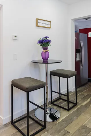a table with a vase and flowers on it