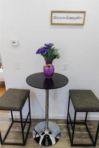 a kitchen with white cabinets and sink