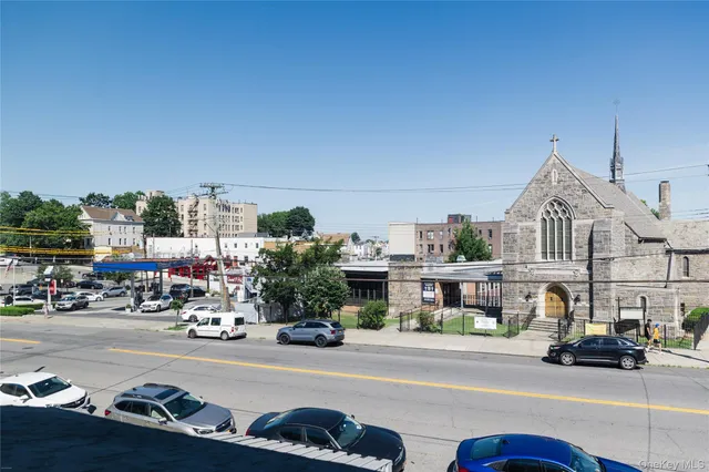 a bedroom with bed and painting on the wall