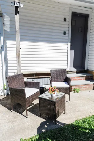 a view of a house with backyard and sitting area