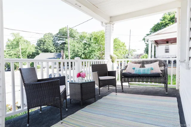 a view of a patio with dining table and chairs