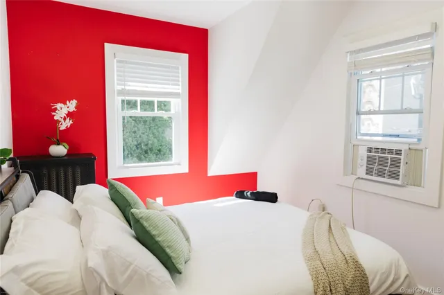 a bedroom with a bed and a painting on the wall