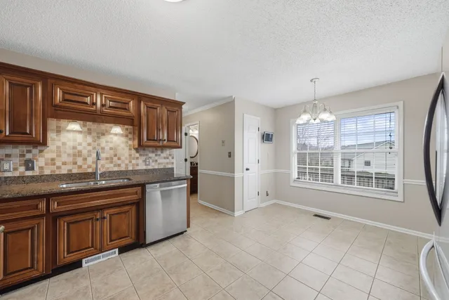 a kitchen with stainless steel appliances granite countertop a stove sink and cabinets