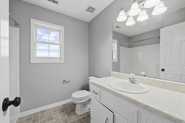 a bathroom with a sink a mirror and a toilet