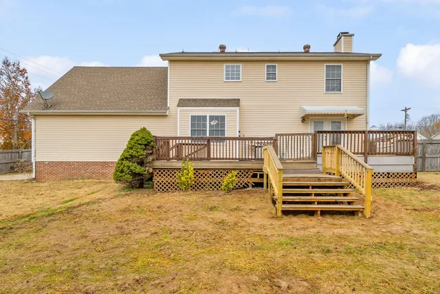 a view of a house with wooden fence