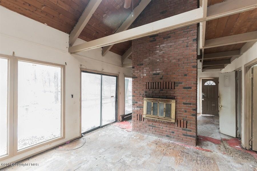131 Rabbit Court Bushkill, PA 18324 - Photo 7 of 12 a view of an empty room with wooden floor and a window
