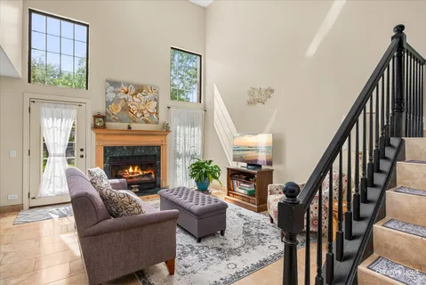 a living room with furniture fireplace and potted plant