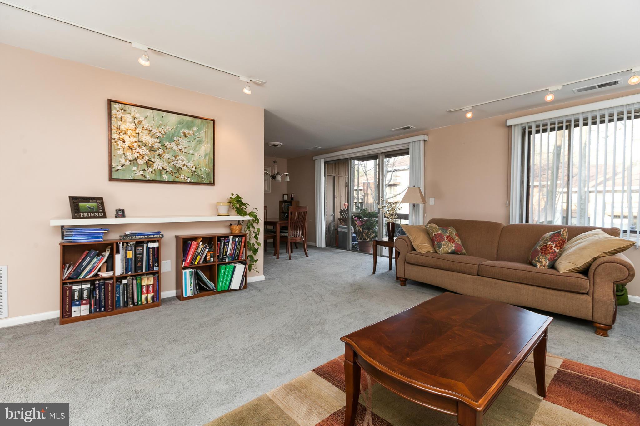 16 Cross Keys Road, Unit 16D Baltimore, MD 21210 - Photo 6 of 29 a living room with lots of furniture and a book shelf