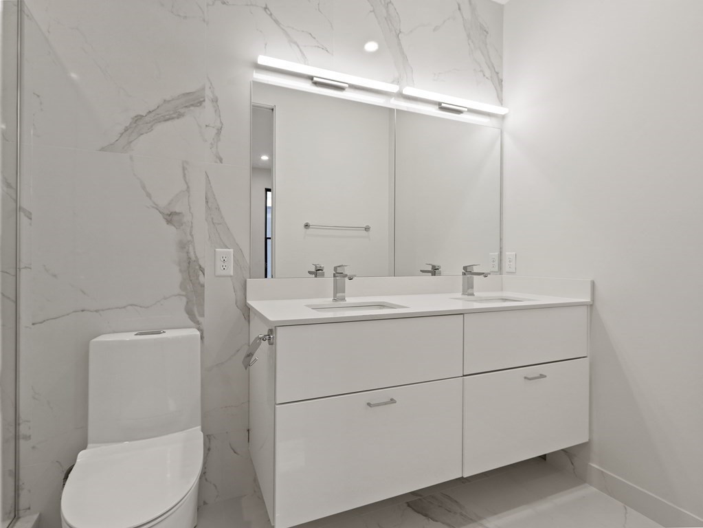 340 West 2nd Street, Unit 8 Boston, MA 02127 - Photo 13 of 38 a bathroom with a toilet sink and mirror