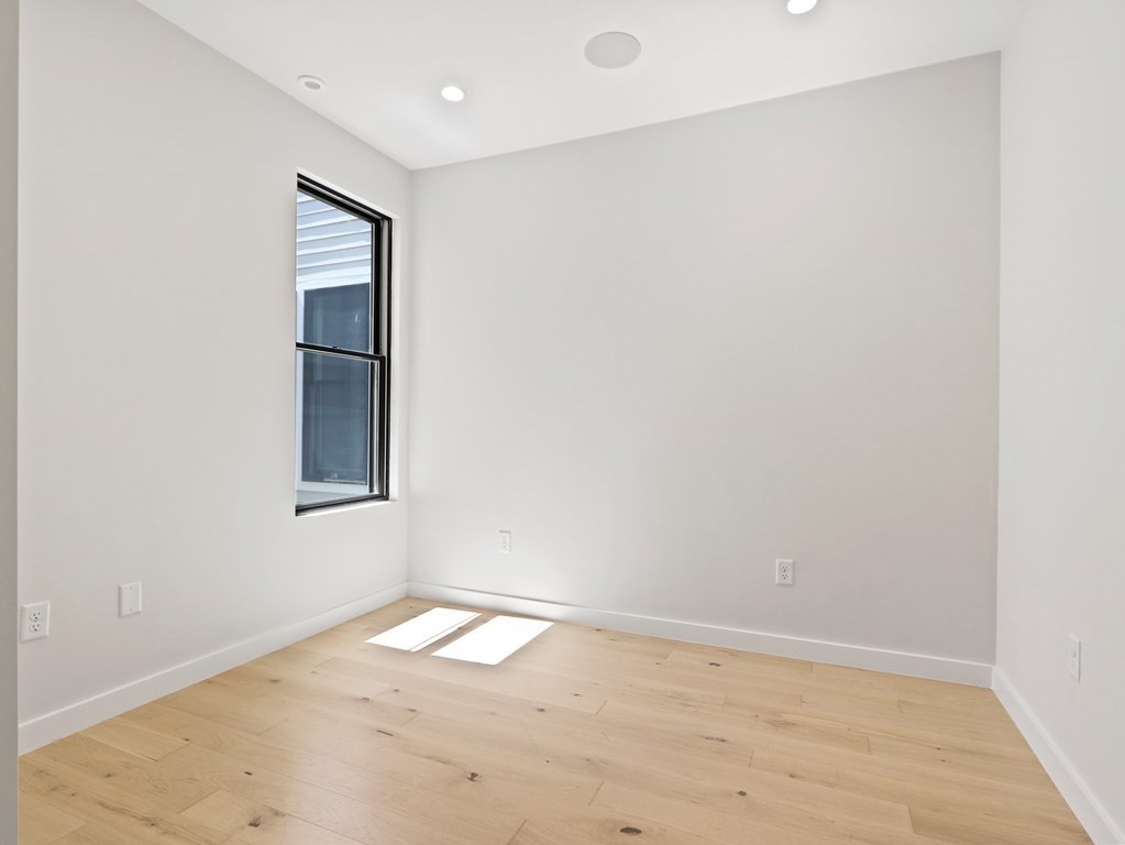 340 West 2nd Street, Unit 8 Boston, MA 02127 - Photo 15 of 38 an empty room with wooden floor and windows