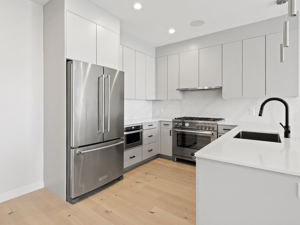 340 West 2nd Street, Unit 8 Boston, MA 02127 - Photo 4 of 38 a kitchen with a refrigerator stove and sink