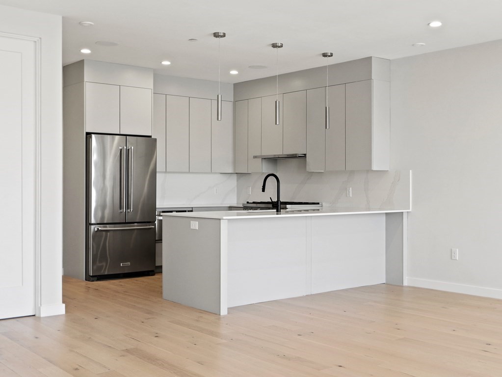 340 West 2nd Street, Unit 8 Boston, MA 02127 - Photo 6 of 38 a kitchen with a refrigerator sink and cabinets