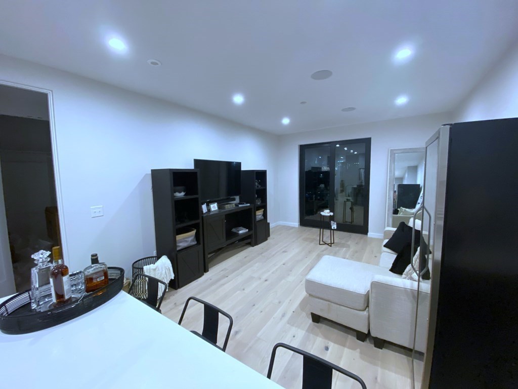 340 West 2nd Street, Unit 8 Boston, MA 02127 - Photo 7 of 38 a living room with furniture and a flat screen tv