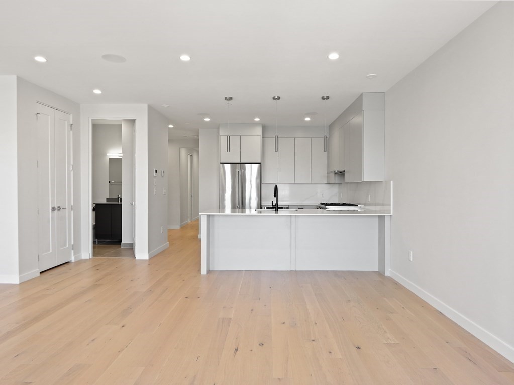 340 West 2nd Street, Unit 8 Boston, MA 02127 - Photo 9 of 38 a view of kitchen with kitchen island white cabinets and stainless steel appliances