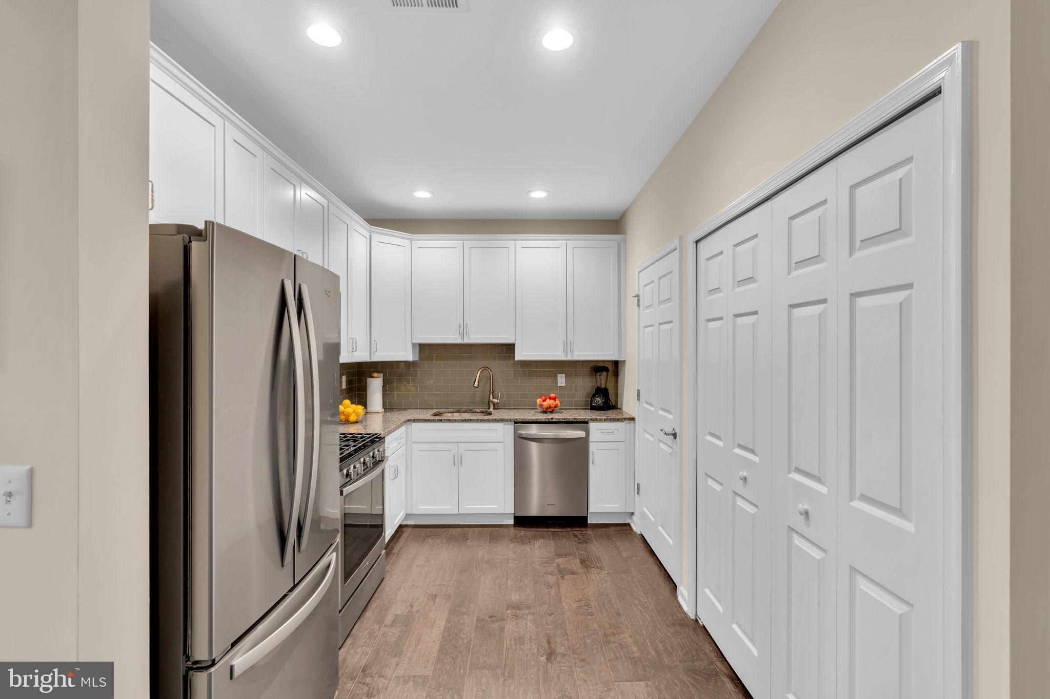 1044 Halifax Place Hamilton, NJ 08619 - Photo 8 of 39 a kitchen with white cabinets and stainless steel appliances