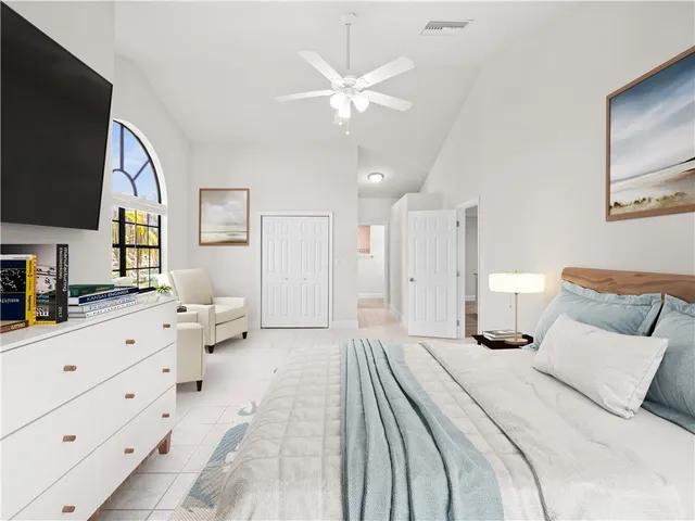 a bed room with a bed a television and dresser