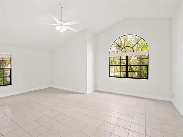 an empty room with windows and entryway