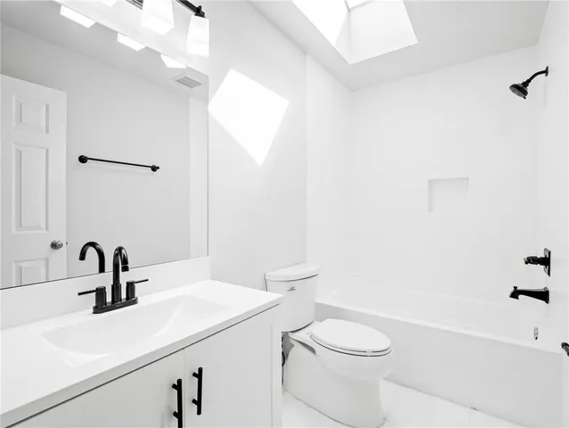 a bathroom with a sink a toilet and a bathtub