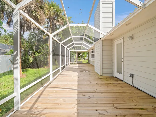 a view of a porch with wooden floor and iron stairs