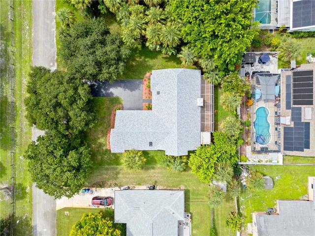 an aerial view of a house with a garden and yard