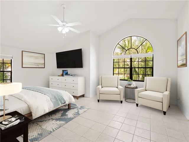 a bedroom with bed and a large window