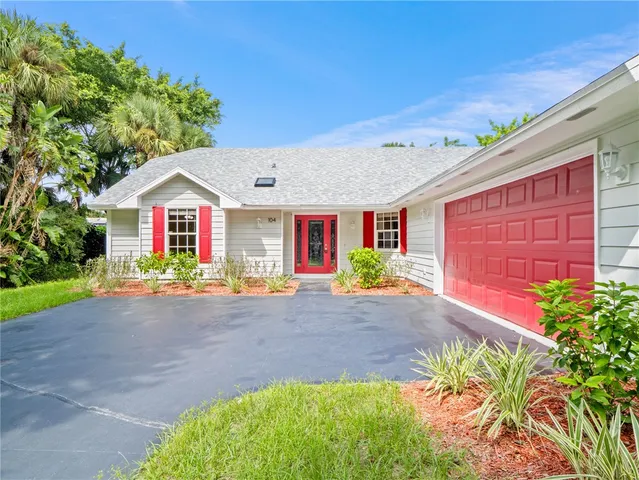 a front view of a house with yard and outdoor seating