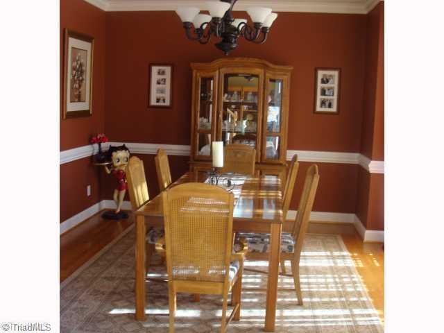 8502 Billet Place Oak Ridge, NC 27310 - Photo 4 of 11 Dining Room. Beautiful Formal Dining Room with Hardwood Flooring and Double Chair Rail.
