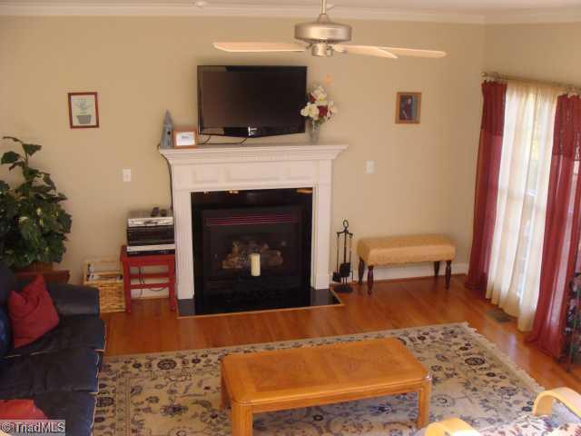 8502 Billet Place Oak Ridge, NC 27310 - Photo 6 of 11 Den/Family/Great Room. Large Family Room with Gas Fireplace and Hardwood Flooring.