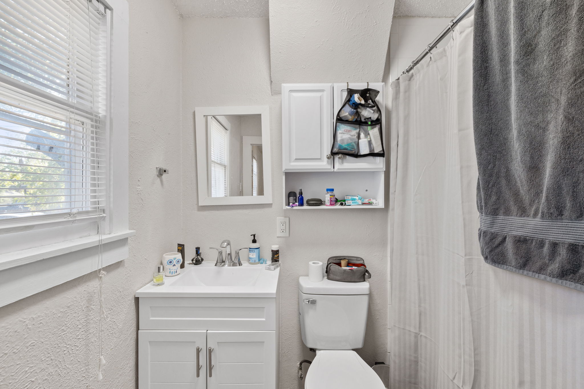 1202 East 29th Street, Unit A Austin, TX 78722 - Photo 20 of 37 a bathroom with a toilet sink and mirror