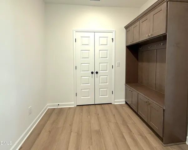a spacious bathroom with a shower a sink and a mirror