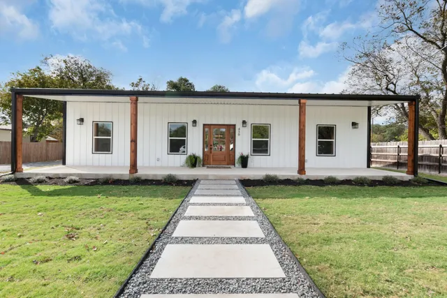 a front view of a house with garden