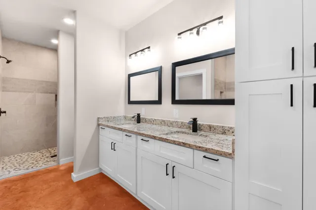 a bathroom with a granite countertop sink a mirror and a