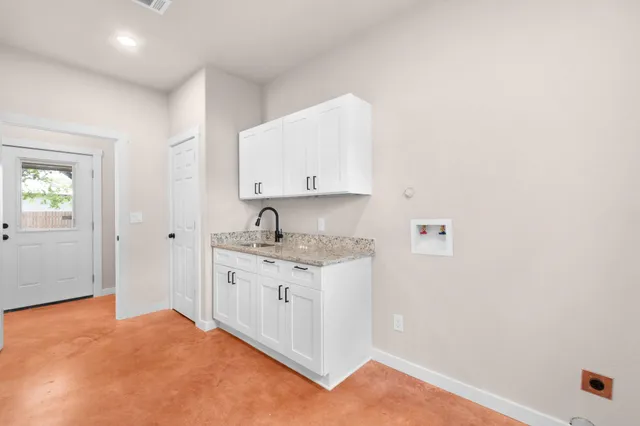 a view of a kitchen with sink and dishwasher