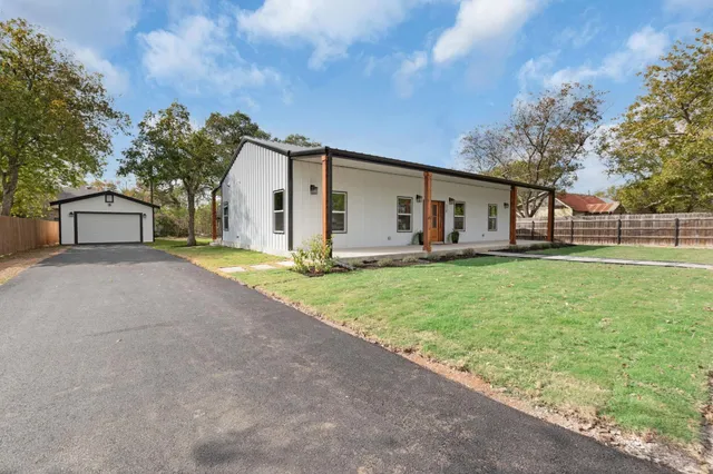 a front view of house with yard and green space