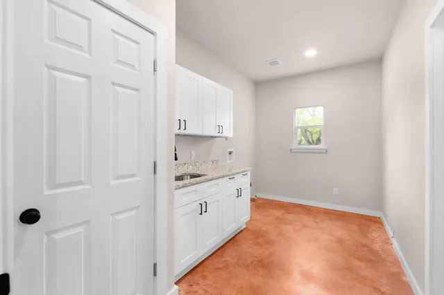 a large white kitchen with white cabinets