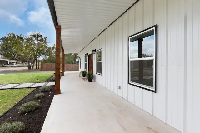 a view of a house with backyard porch and sitting area