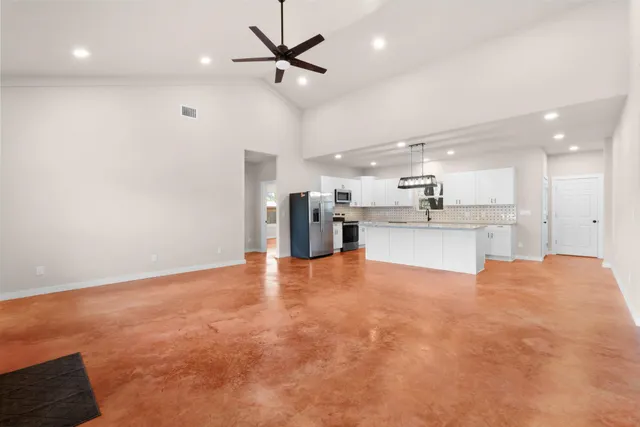 a view of a kitchen with a sink and a refrigerator