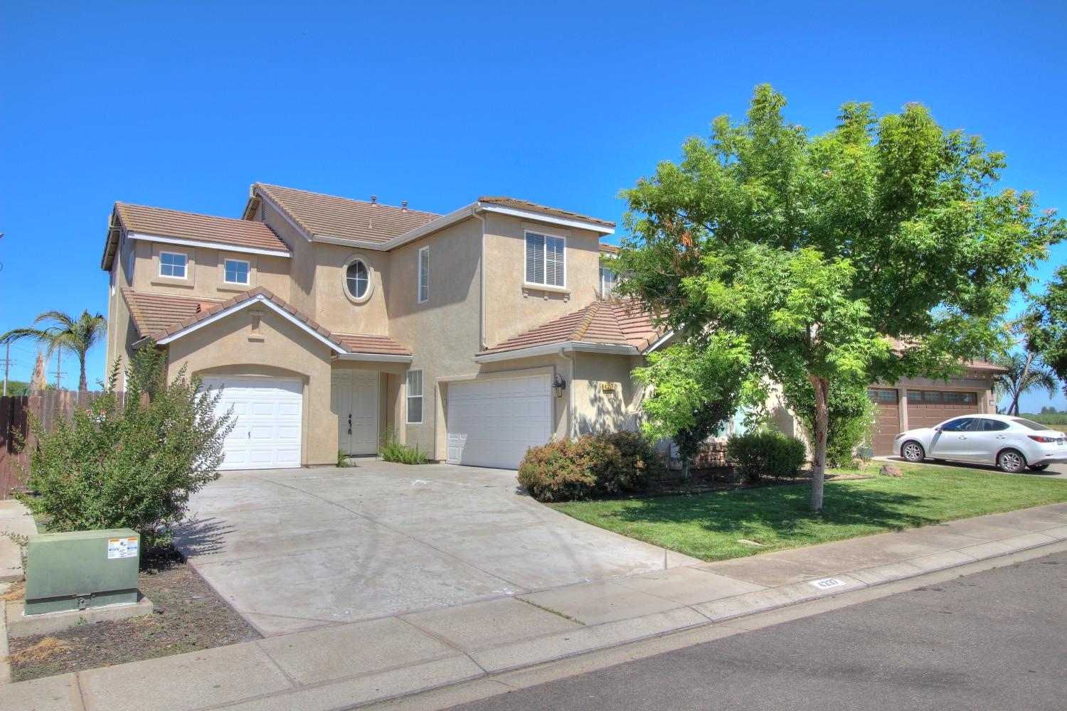 4337 Peninsula Drive Modesto, CA 95356 - Photo 1 of 1 a front view of a house with a garden