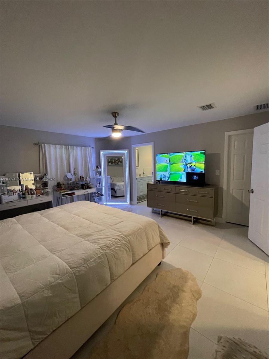 20605 Southwest 319th Street Homestead, FL 33030 - Photo 23 of 67 a bed room with a bed and a television