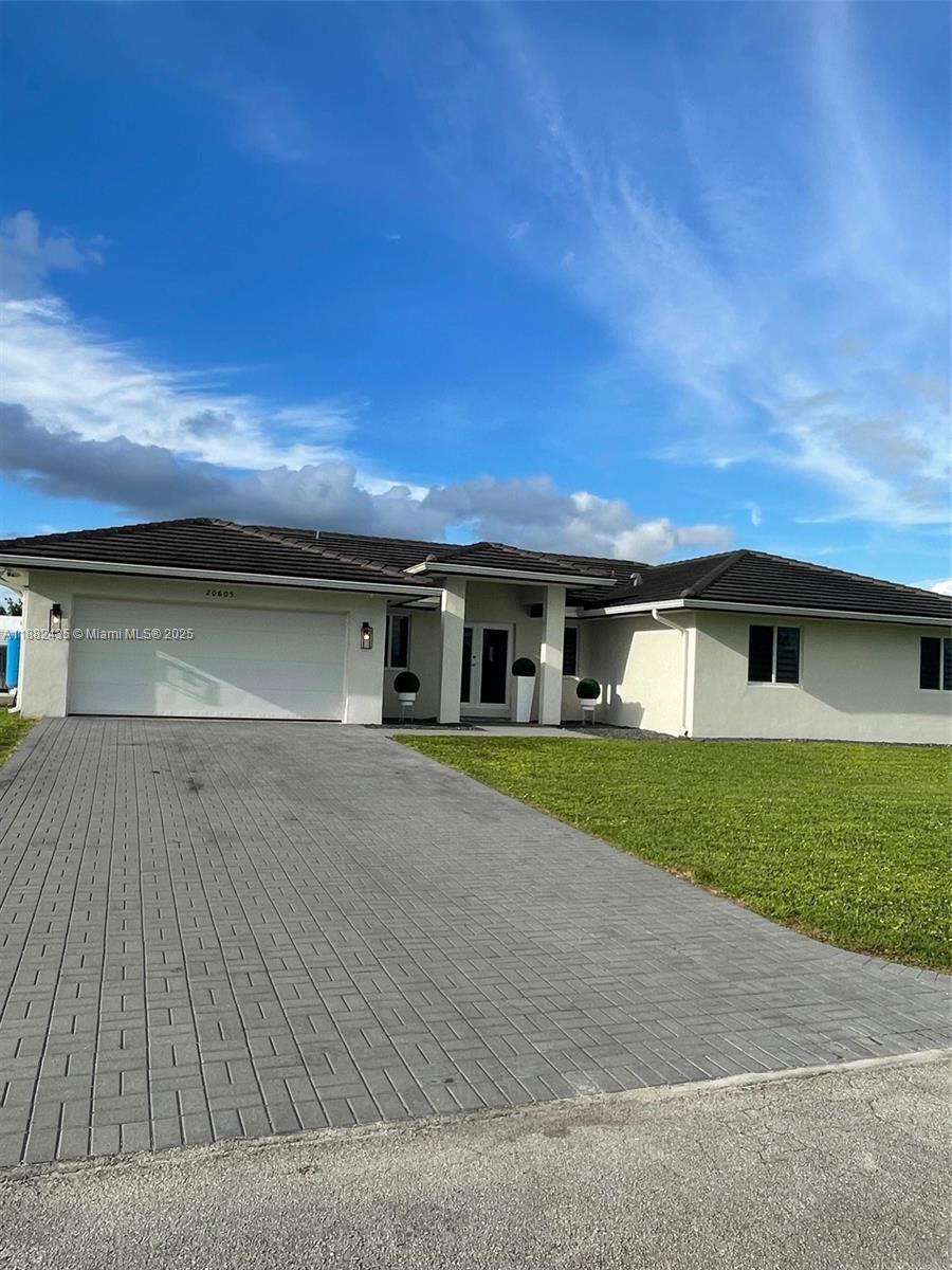20605 Southwest 319th Street Homestead, FL 33030 - Photo 3 of 67 front view of a house with a yard