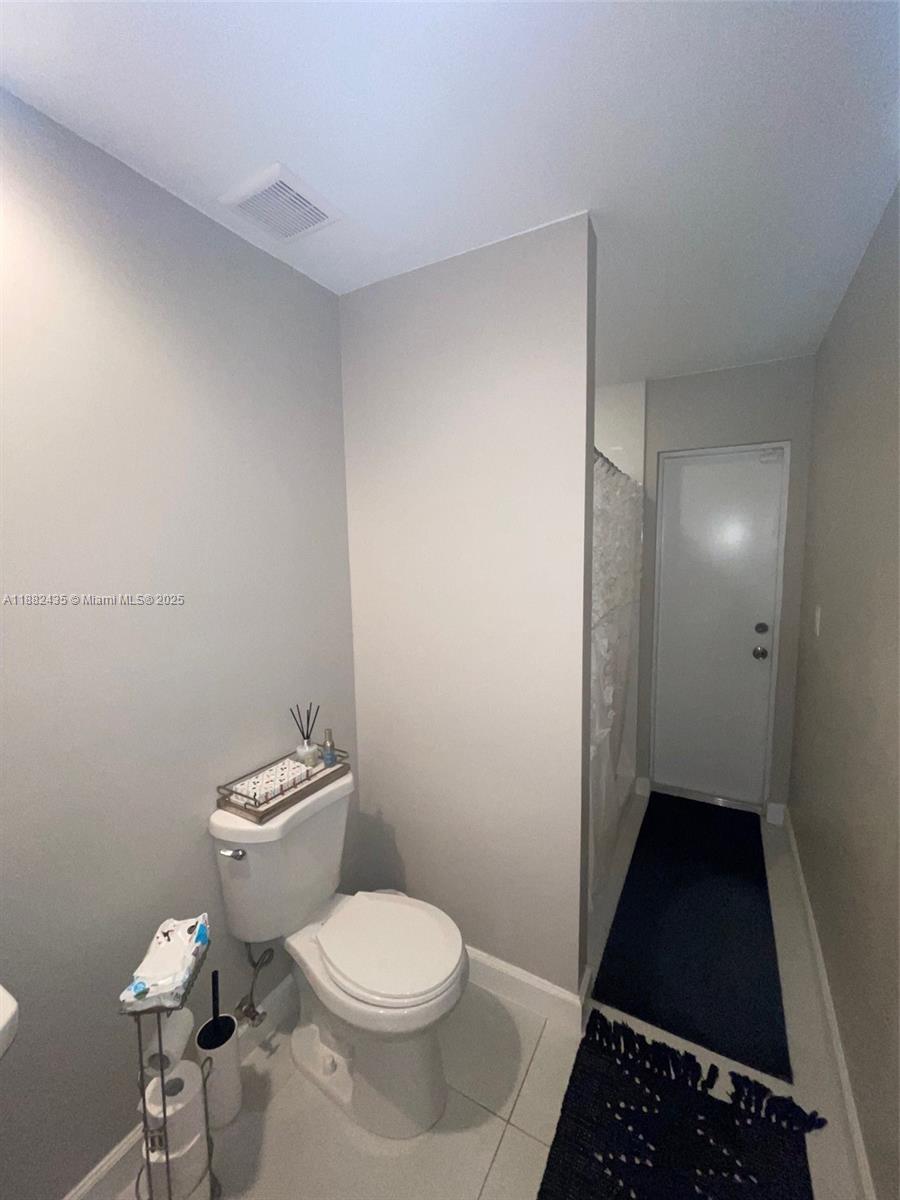 20605 Southwest 319th Street Homestead, FL 33030 - Photo 32 of 67 a bathroom with a toilet and a shower