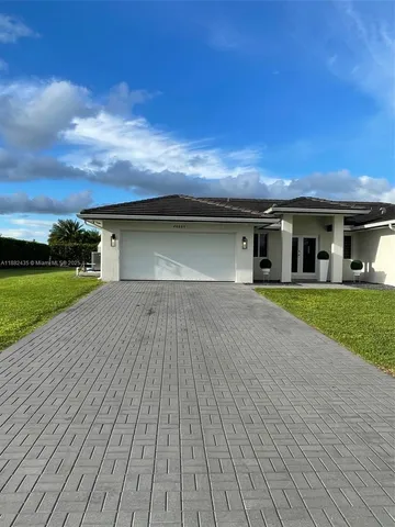 a kitchen with stainless steel appliances a refrigerator a stove a sink a washer and dryer