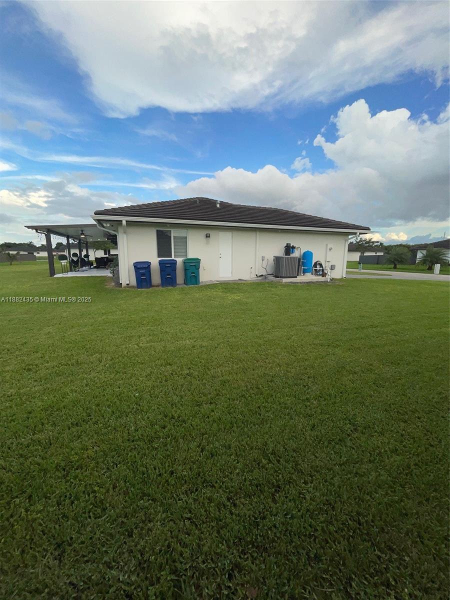 20605 Southwest 319th Street Homestead, FL 33030 - Photo 47 of 67 a view of a big house with a big yard