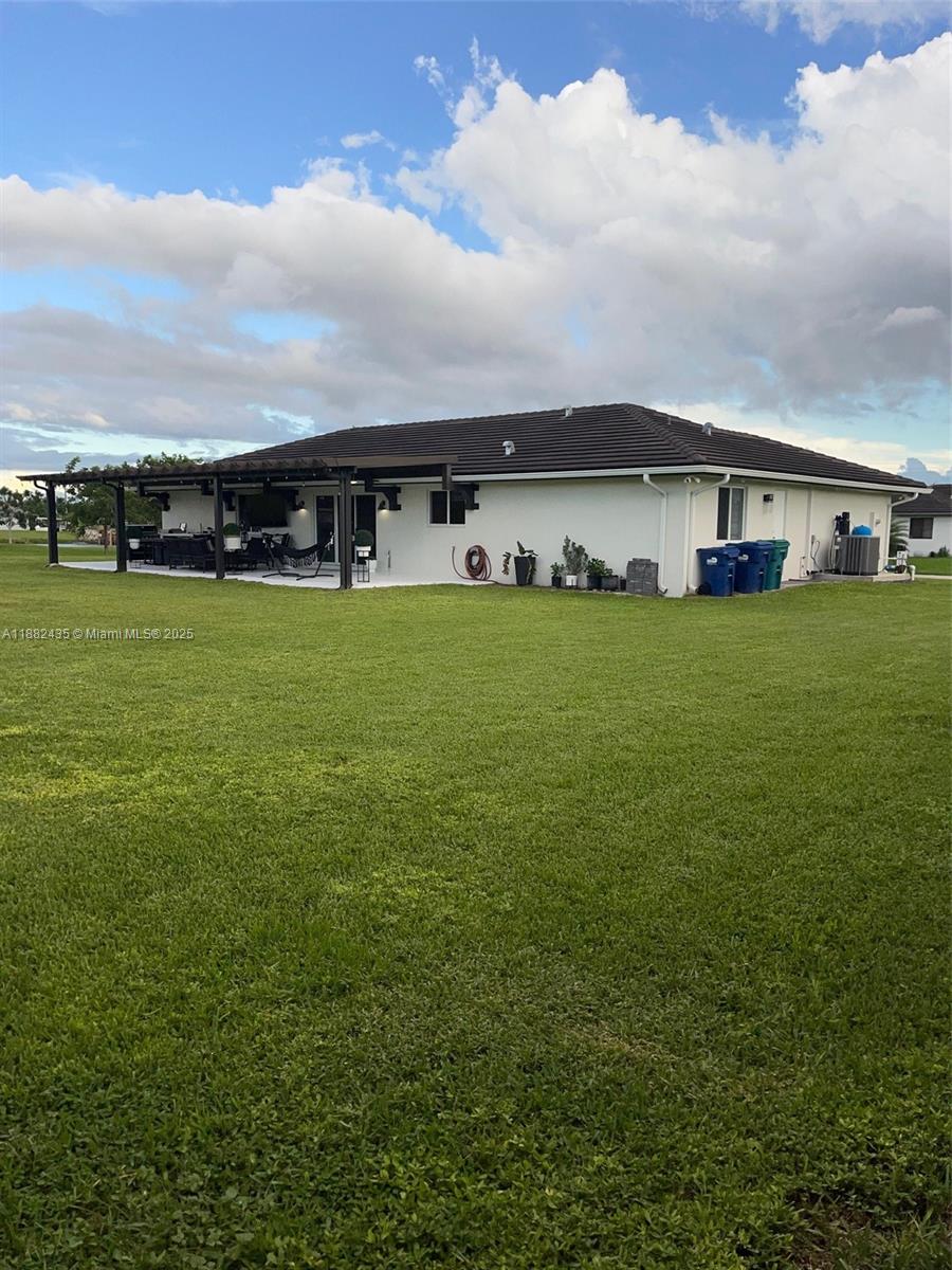 20605 Southwest 319th Street Homestead, FL 33030 - Photo 53 of 67 a view of a big house with a big yard