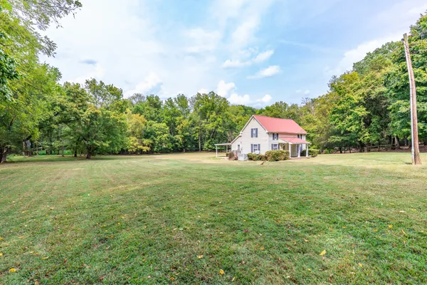 a backyard of a house with lots of trees