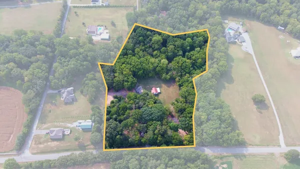 an aerial view of residential houses with outdoor space and street view
